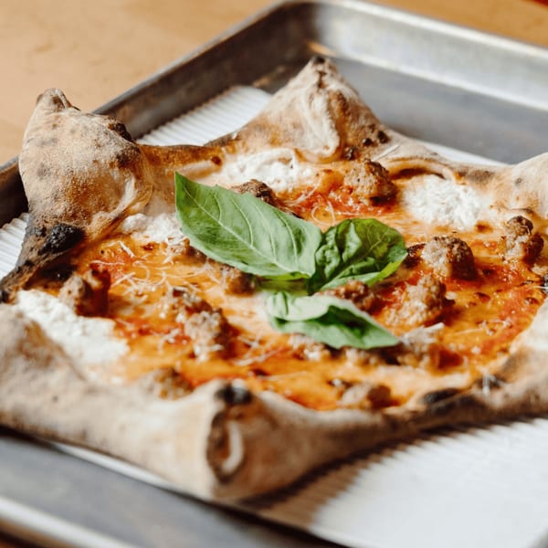 DeSano Pizzeria Napoletana's square pizza with sausage, red sauce, cheese, and fresh basil.